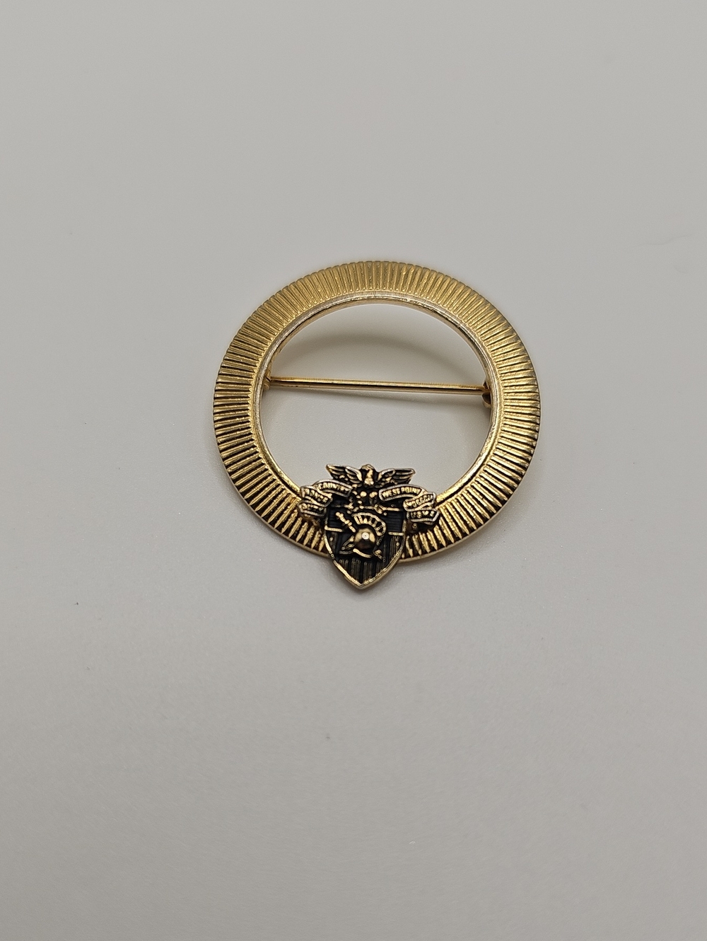 Gold Tone  Circular Emblem Point West Brooch with Crest